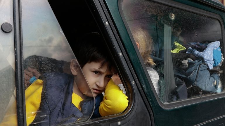 An ethnic Armenian boy from Nagorno-Karabakh, looks on from a...