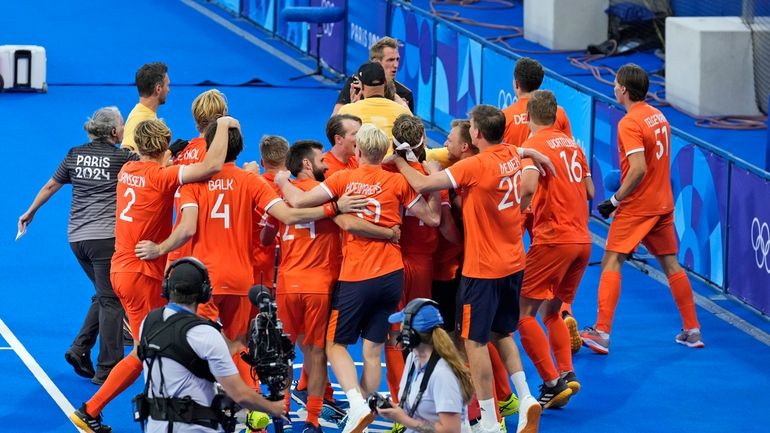 Germany's Niklas Wellen, center behind, is pacified as he approaches...