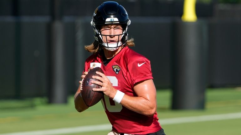 Jacksonville Jaguars quarterback Trevor Lawrence looks for a receiver during...