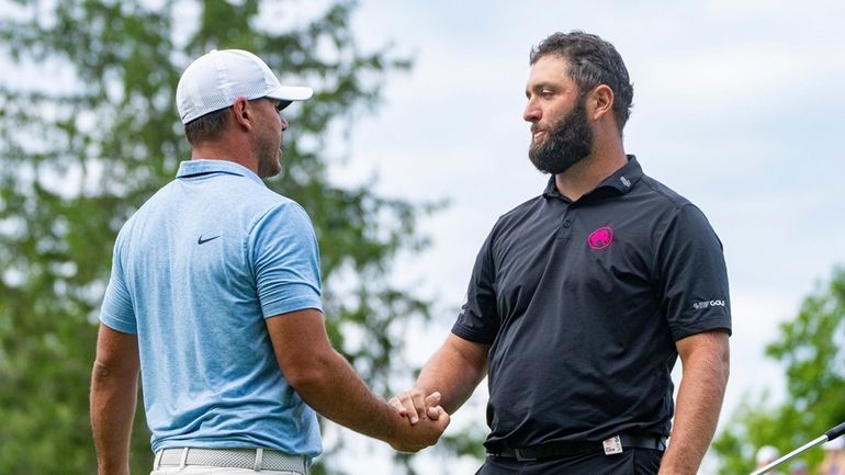 Captain Brooks Koepka, left, of Smash GC, shakes hands with...