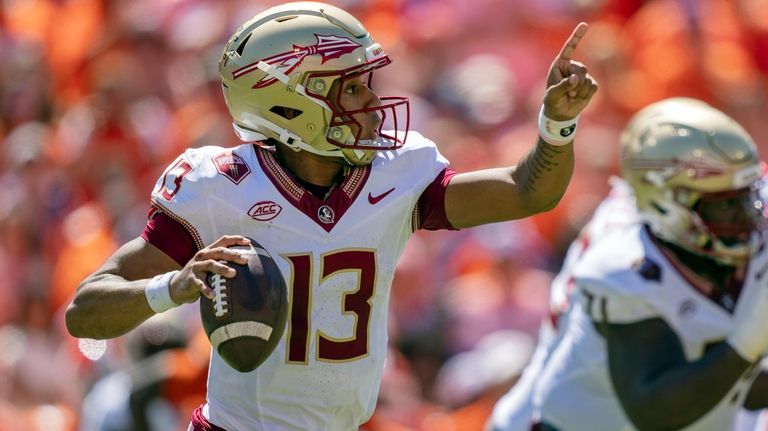 Florida State quarterback Jordan Travis (13) directs a play during...