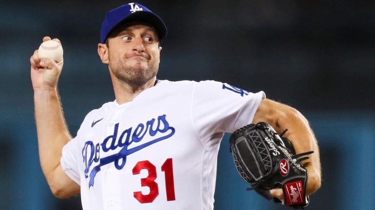 Dodgers starting pitcher Max Scherzer throws against the Padres in the...