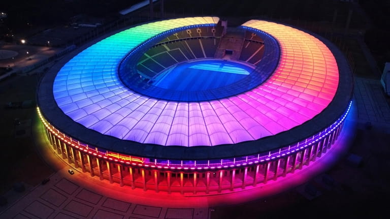 The rainbow-illuminated Olympic Stadium is pictured in Berlin, Germany, Wednesday,...