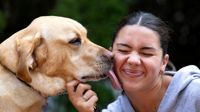 Pagonis plays with her guide dog, Radar.