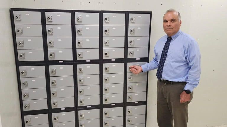 Dean of Students Corey Farris shows the storage locker at...