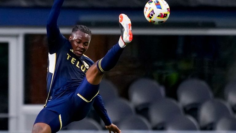 Vancouver Whitecaps defender Javain Brown, top, collides with Seattle Sounders...