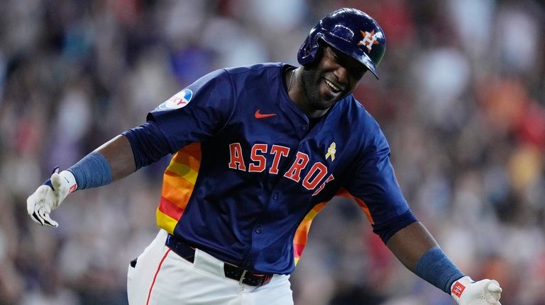 Houston Astros' Yordan Alvarez celebrates after hitting a solo home...