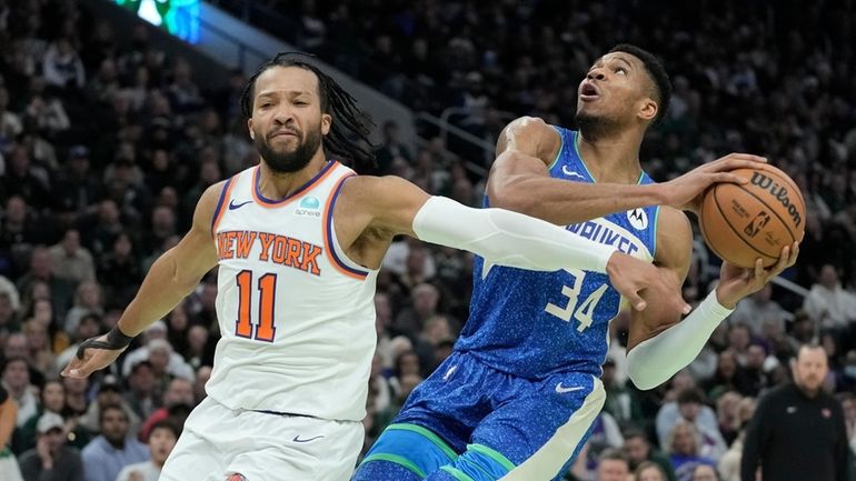 Milwaukee Bucks' Giannis Antetokounmpo drives past Knicks' Jalen Brunson during the...