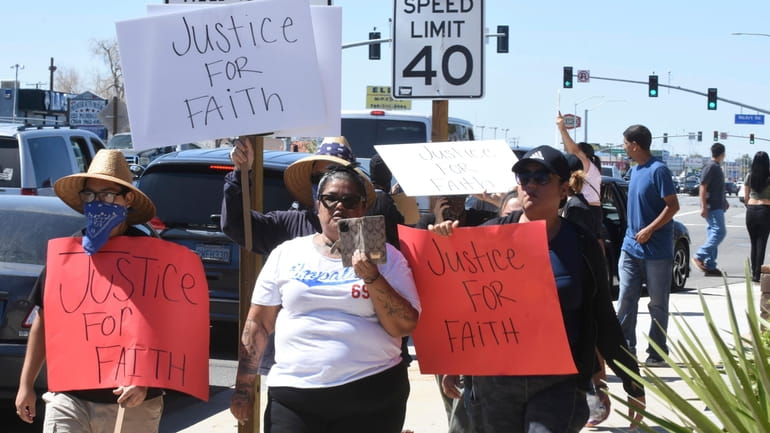 Priscilla Jeffers, center, walks down Palmdale Road during a protest...