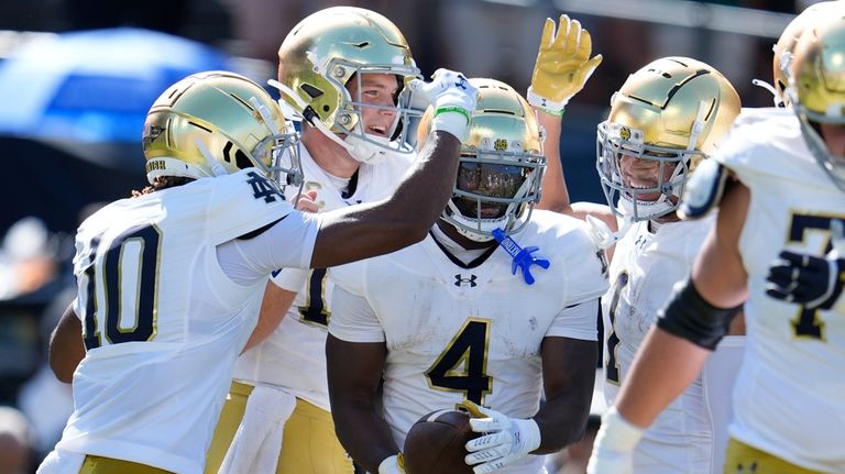 Notre Dame running back Jeremiyah Love (4) is congratulated by...