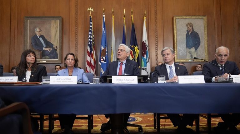 Attorney General Merrick Garland, center, speaks before a meeting of...