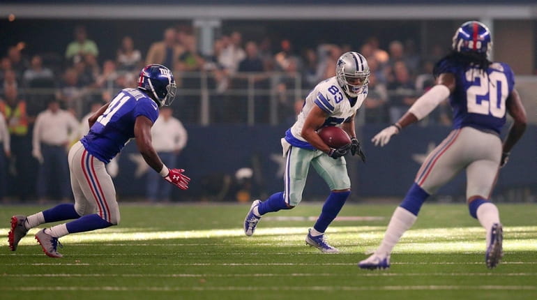Terrance Williams of the Dallas Cowboys carries the ball against...