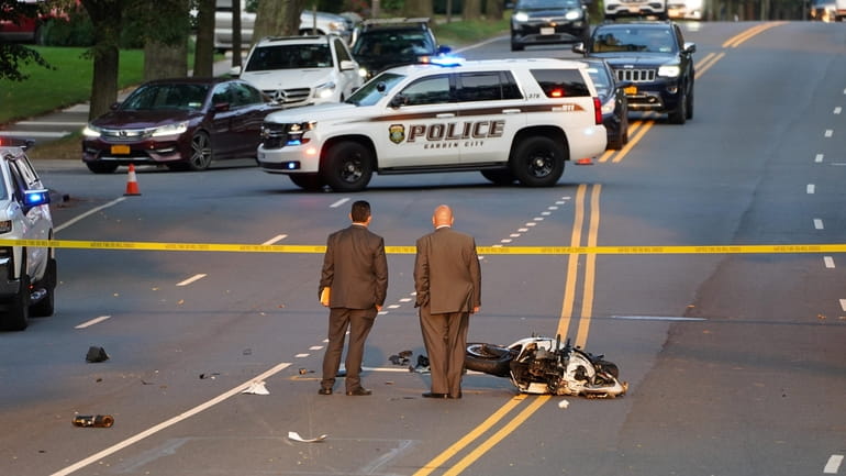 Investigators on the scene of a fatal motorcycle accident on...