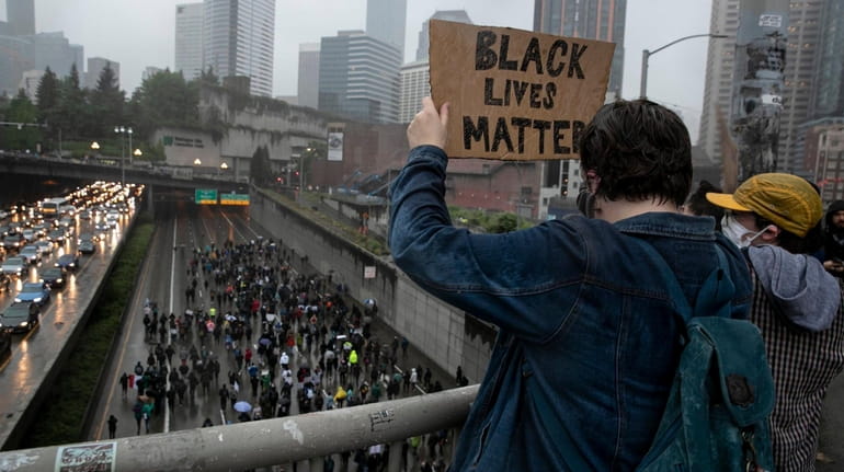 Crowds demonstrate against police brutality on I-5 in Seattle, Saturday,...
