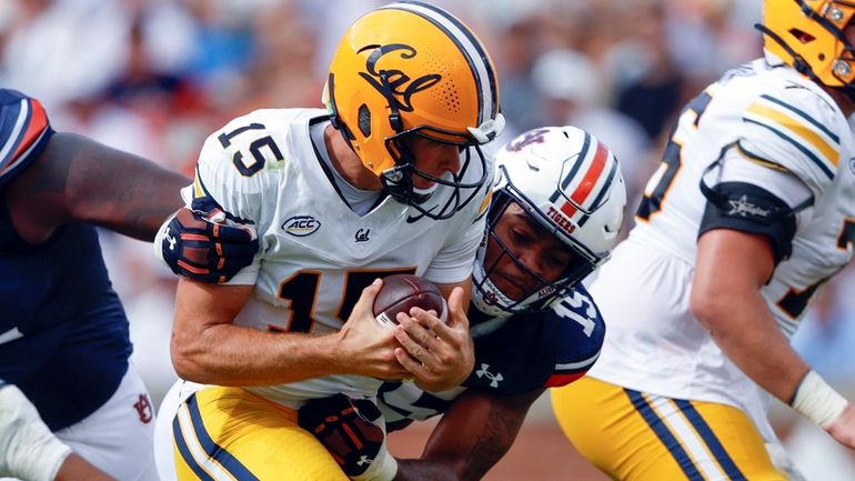 California quarterback Fernando Mendoza, center left, is sacked by Auburn...