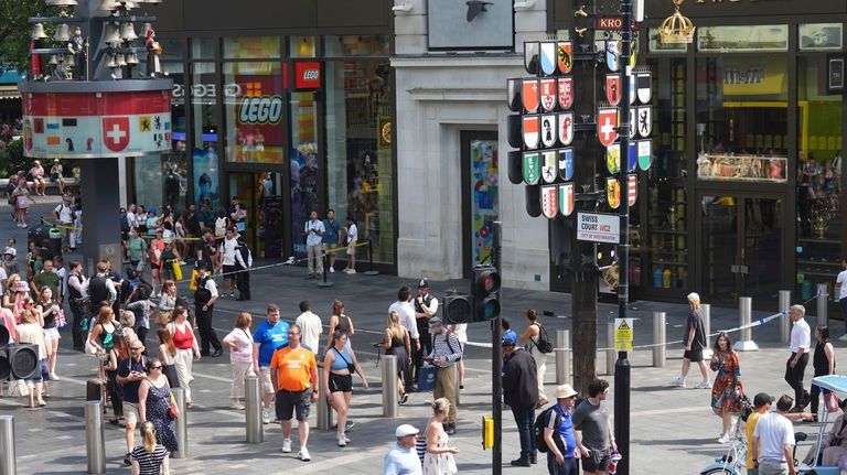 Police cordon off an area in Leicester Square, as a...