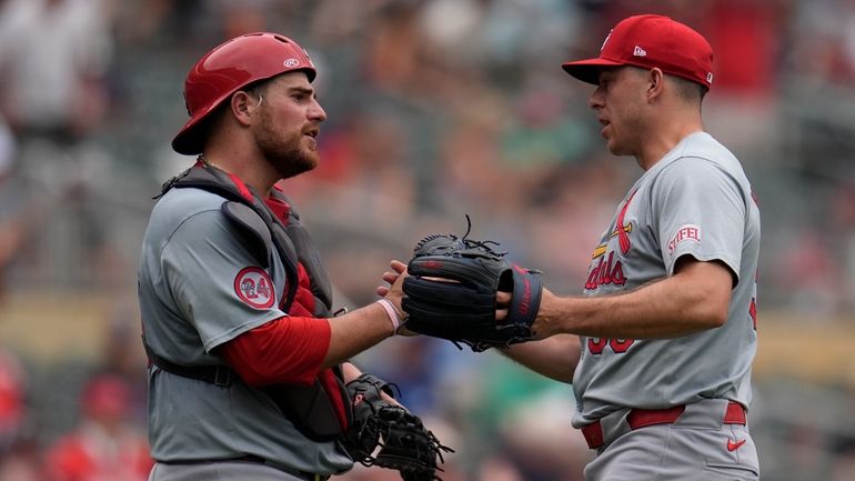 St. Louis Cardinals catcher Pedro Pages, left, and relief pitcher...