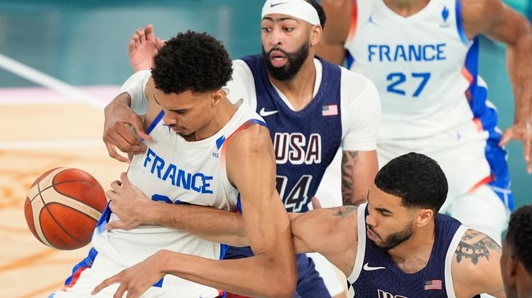 United States' Jayson Tatum (10) knocks the ball from Victor...