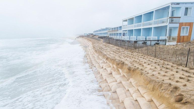 Sandbags are exposed in front of the Montauk Blue Hotel,...