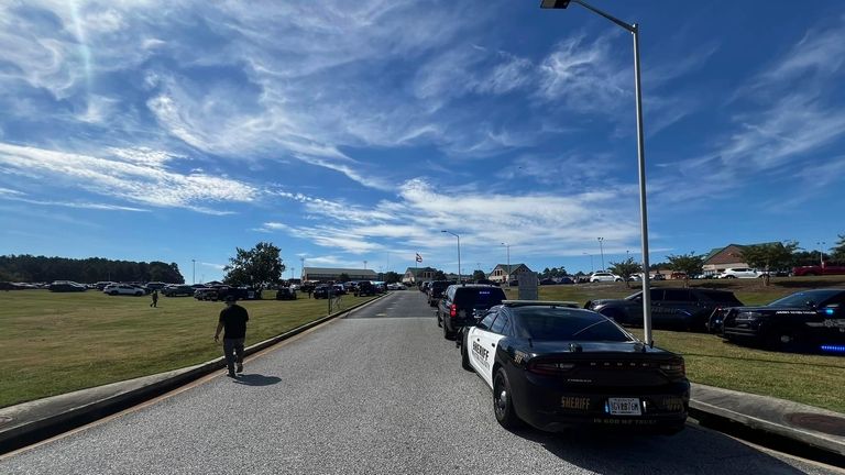 Law enforcement arrive as students are evacuated to the football...