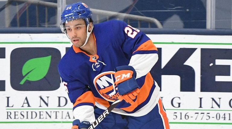 Islanders forward Joshua Ho-Sang controls the puck against the Flyers...