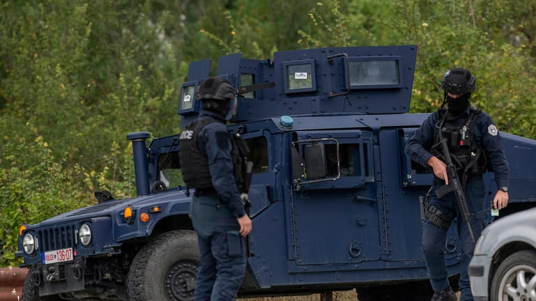 Kosovo police officers man a checkpoint near Banjska Monastery during...