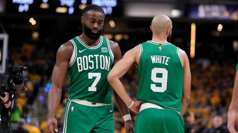 Boston Celtics guard Jaylen Brown (7) talks with teammate guard...