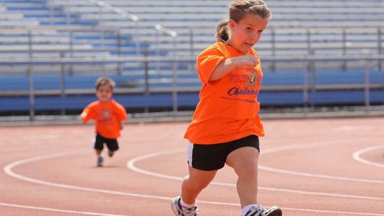 Loren Karabatzoglou, 13, of Islip, gets ahead in the 200-meter...