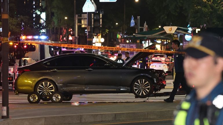 Police officers control a car accident scene near Seoul City...