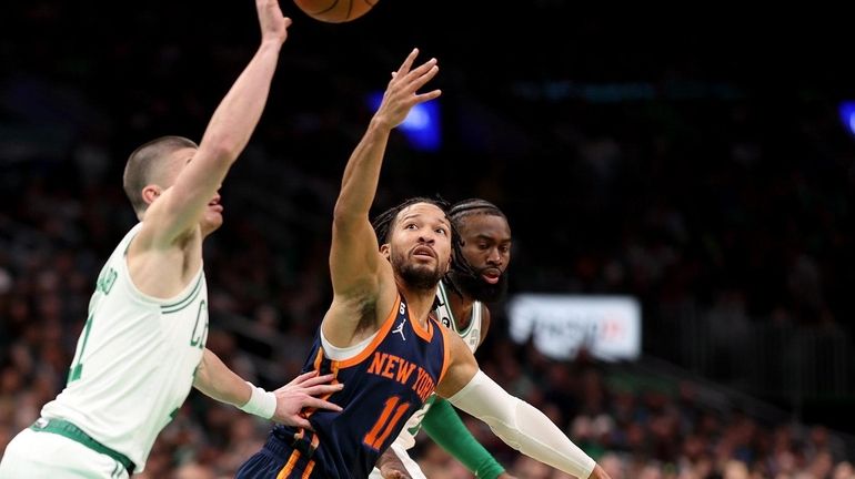 Payton Pritchard #11 of the Boston Celtics and Jalen Brunson...