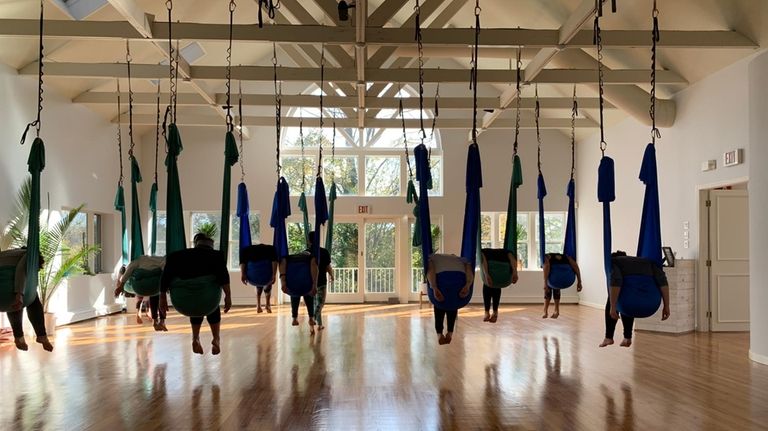 Sound Body & Mind in Huntington offers an aerial yoga...