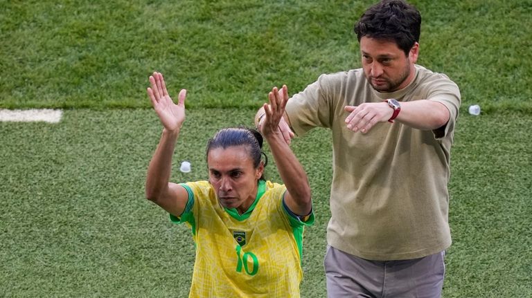 Brazil's head coach Elias Arthur, right, gestures towards Brazil's Marta,...