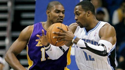 Orlando Magic's Dwight Howard, right, makes a move to get...