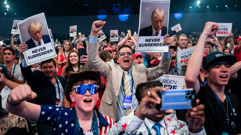 Supporters cheer as Republican presidential candidate and former president Donald...