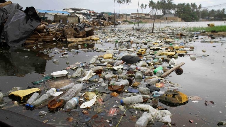 Plastic fills waters in Port Bouet outside Abidjan, Ivory Coast,...