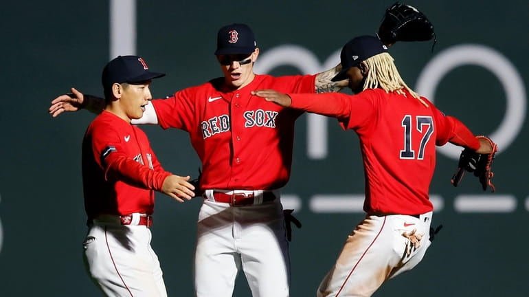 Boston Red Sox outfielders, from left to right, Masataka Yoshida,...