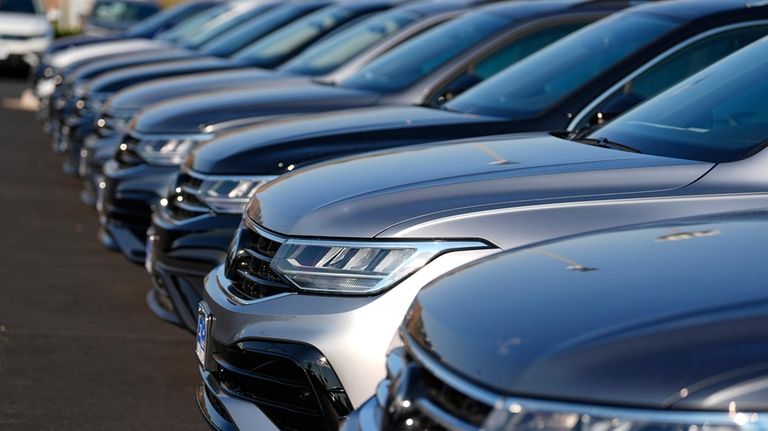 A row of unsold 2024 Tiguan utility vehicles are shown...