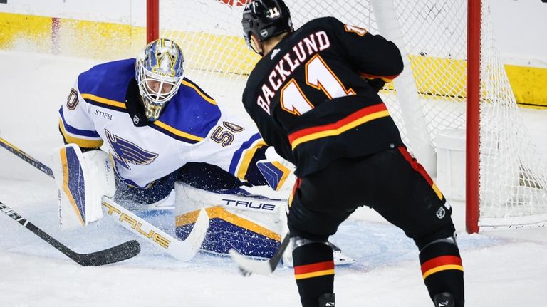 St. Louis Blues goalie Jordan Binnington (50) lunges to stop...