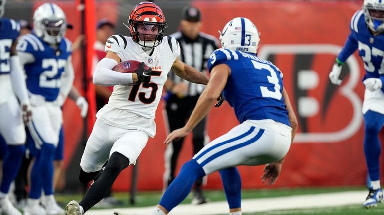 Cincinnati Bengals' Charlie Jones (15) runs from Indianapolis Colts place...