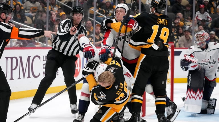 Washington Capitals' Rasmus Sandin (38) takes down Pittsburgh Penguins' Lars...