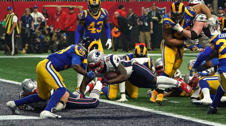 New England running back Sony Michel, center, scores a touchdown during Super...