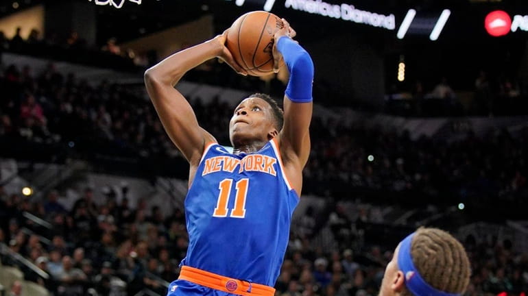 Knicks guard Frank Ntilikina dunks during a game against the...