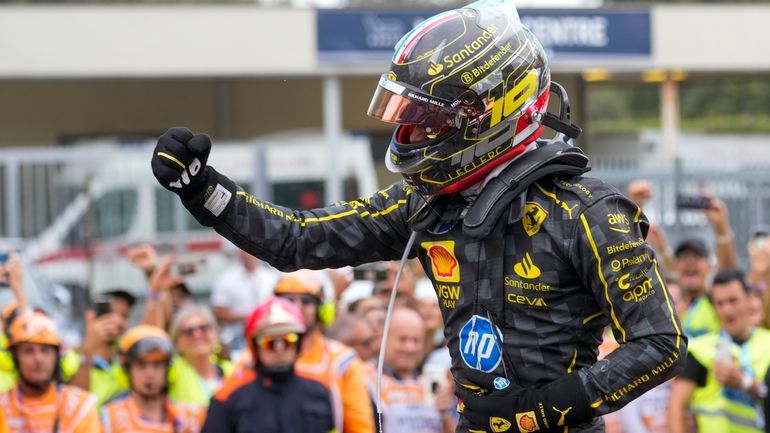 Ferrari driver Charles Leclerc of Monaco celebrates after winning the...