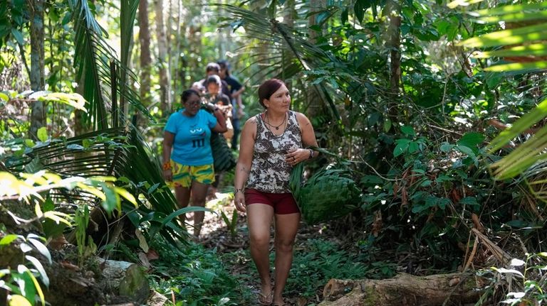 Juma Indigenous sisters Mandei Juma, right, and Borea Juma walk...