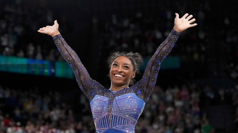 Simone Biles, of the United States, celebrates after performing in...