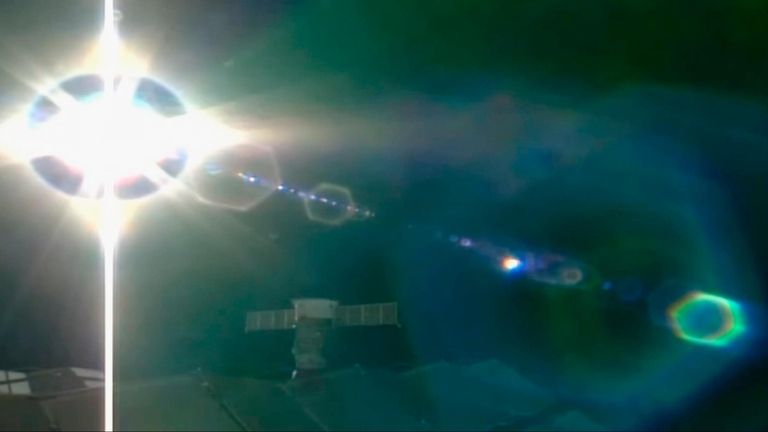 This screen grab from a NASA feed shows glare reflecting...