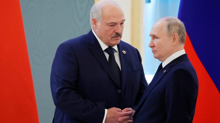 Belarusian President Alexander Lukashenko, left, and Russian President Vladimir Putin...