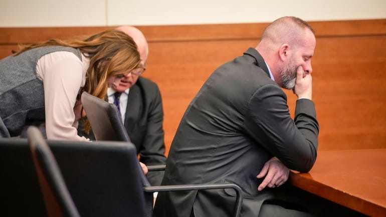 Jason Meade covers his face while waiting for Judge David...