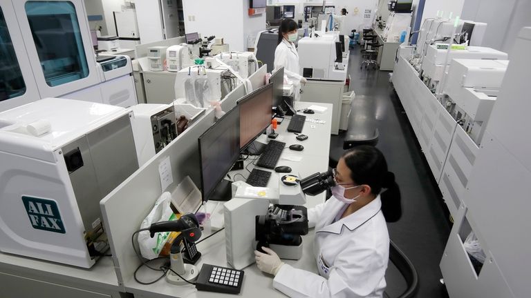 A medical technologist performs tests at the department of laboratory...