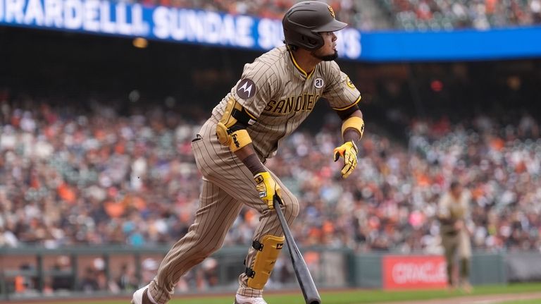 San Diego Padres' Luis Arraez watches his double during the...